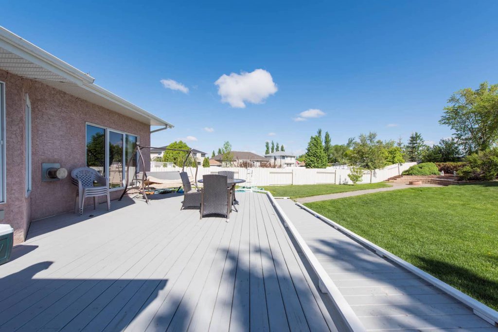 The large deck is ramped with regulation ratio (1":12") , with a bumper along deck edges and ramp to a paving stone walkway that leads to an accessible firepit. Paving stone has slightly sunken over the years, but can be maintained by building it up with more sand.