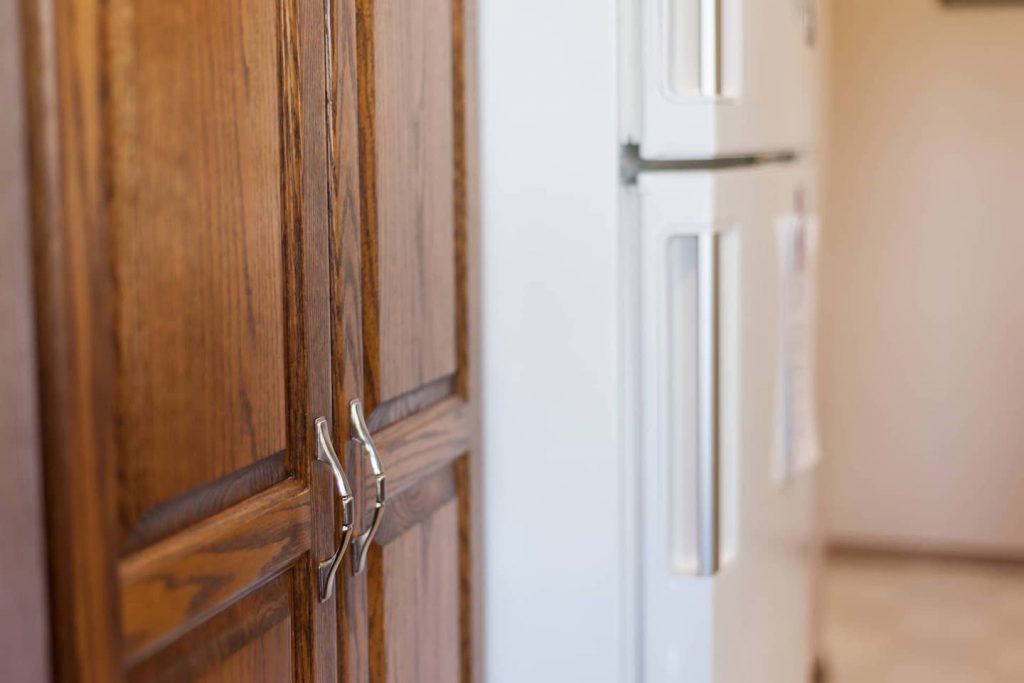 Deep handles on cupboards and frefrigerator make grasping easier.