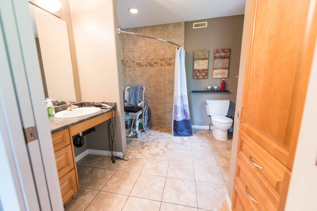Master bath has a wheel in shower, and wheel under sink, with low pull out drawers beside the sink, and in the pantry.