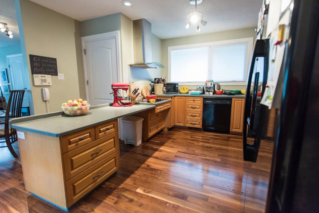 There is a large counter with open space underneath, and a slight cutout under the stove.