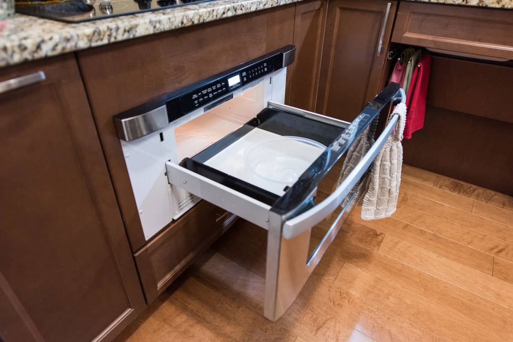 Having the microwave built into the cupboard space gives added countertop space for working at, and is at a good height.